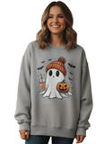 Woman wearing a gray sweatshirt with a Halloween-themed ghost design.