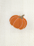 Embroidered pumpkin patch on a textured white fabric background