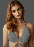 Woman wearing a gray crochet bikini top against a gray background