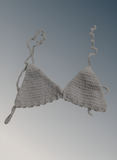Crocheted bikini set on a gradient gray background