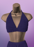 Purple crochet top on a mannequin against a purple background