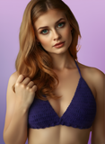 Woman wearing a purple bralette against a purple background