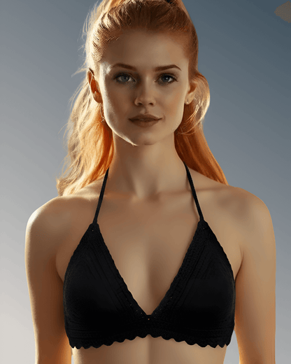 Woman wearing a black bikini top against a neutral background