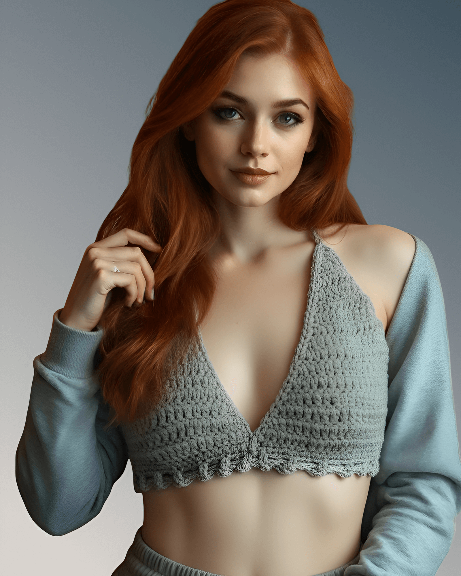 Woman wearing a gray crochet top and light blue sweater against a neutral background