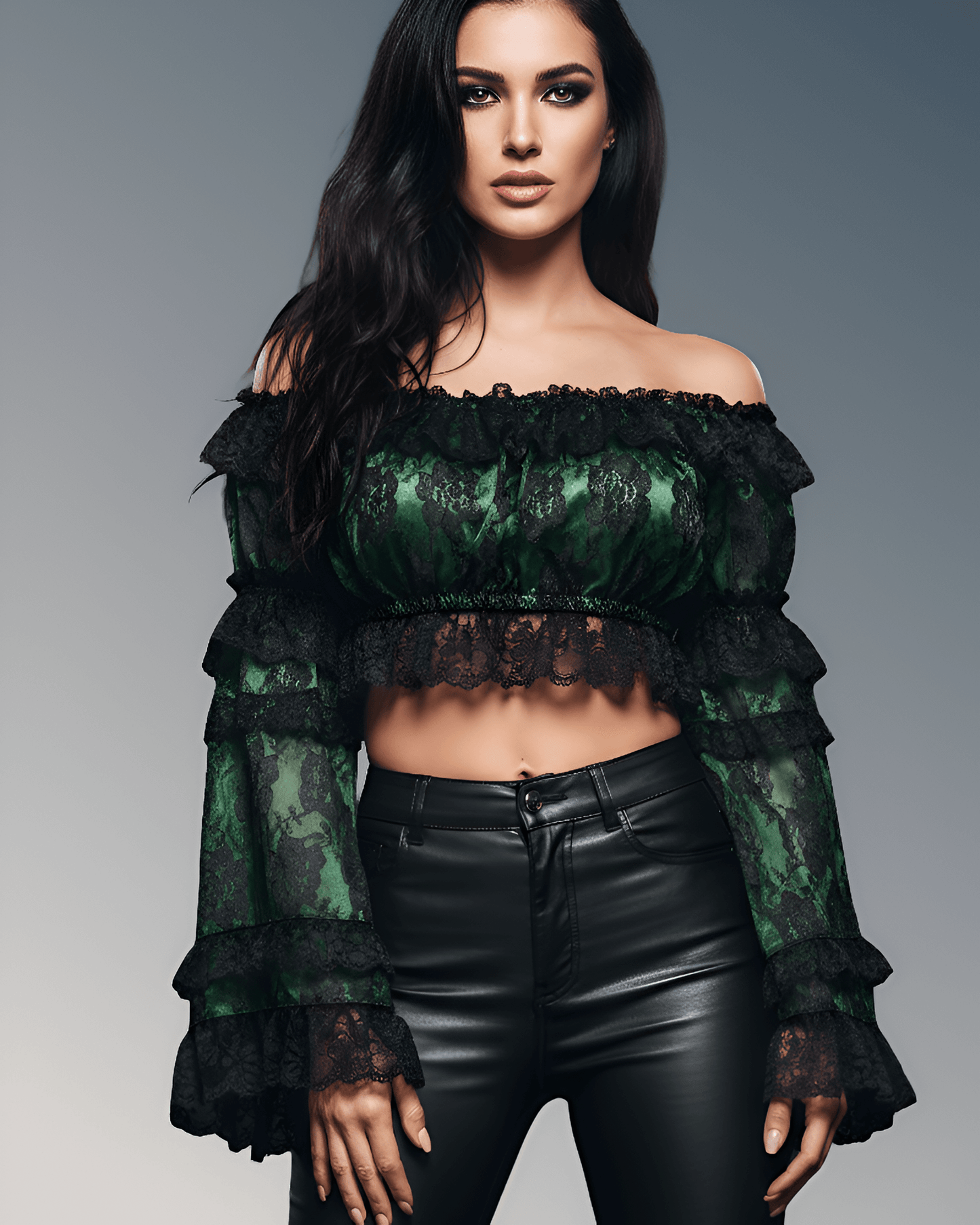 Woman wearing a green lace top and black leather pants on a gray background