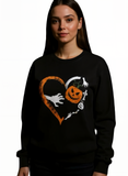 Black sweatshirt with Halloween-themed design featuring a pumpkin, ghost, and skeleton hand in a heart shape.