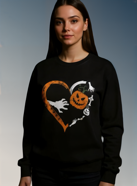 Person wearing a black sweatshirt with Halloween-themed design on a gray background