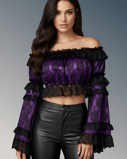 Woman wearing a purple lace top with black ruffles on a gray background