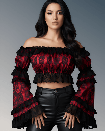 Woman wearing a red and black off-shoulder top with ruffled sleeves against a gray background