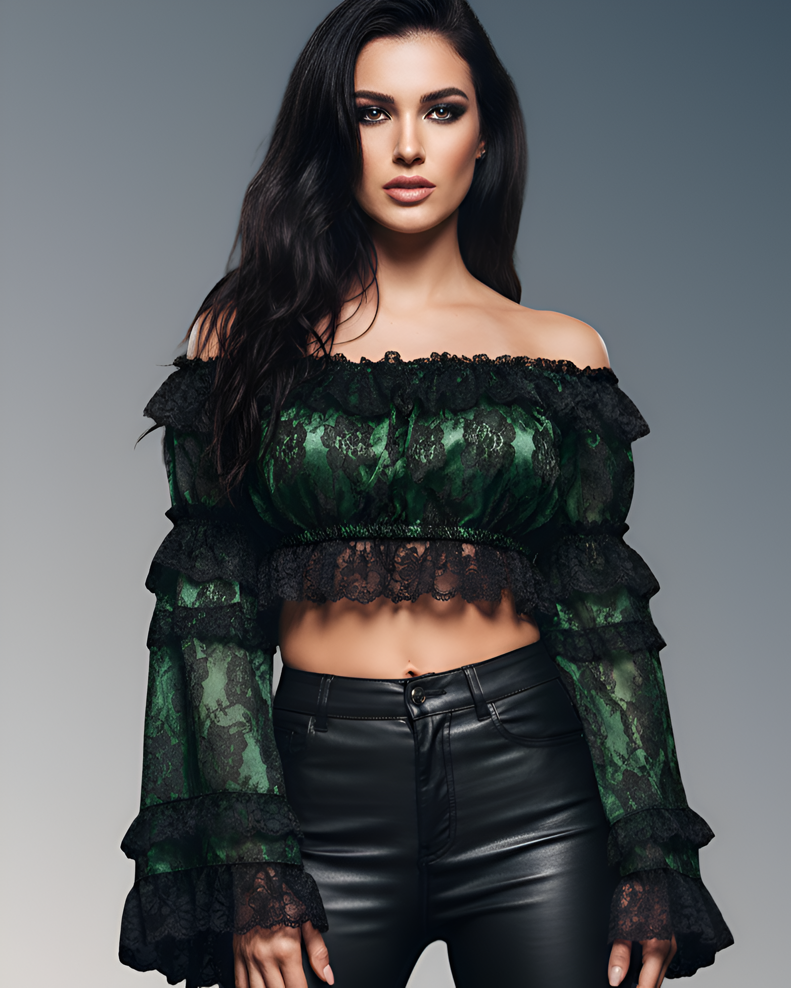 Woman wearing a green lace top and black leather pants against a gray background