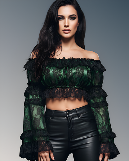 Woman wearing a green lace top and black leather pants against a gray background