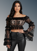 Woman wearing a black lace top and leather pants on a gray background