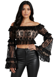 Woman wearing a black lace top and leather pants on a white background