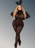 Person wearing a black patterned bodysuit with bunny ears on a gray background